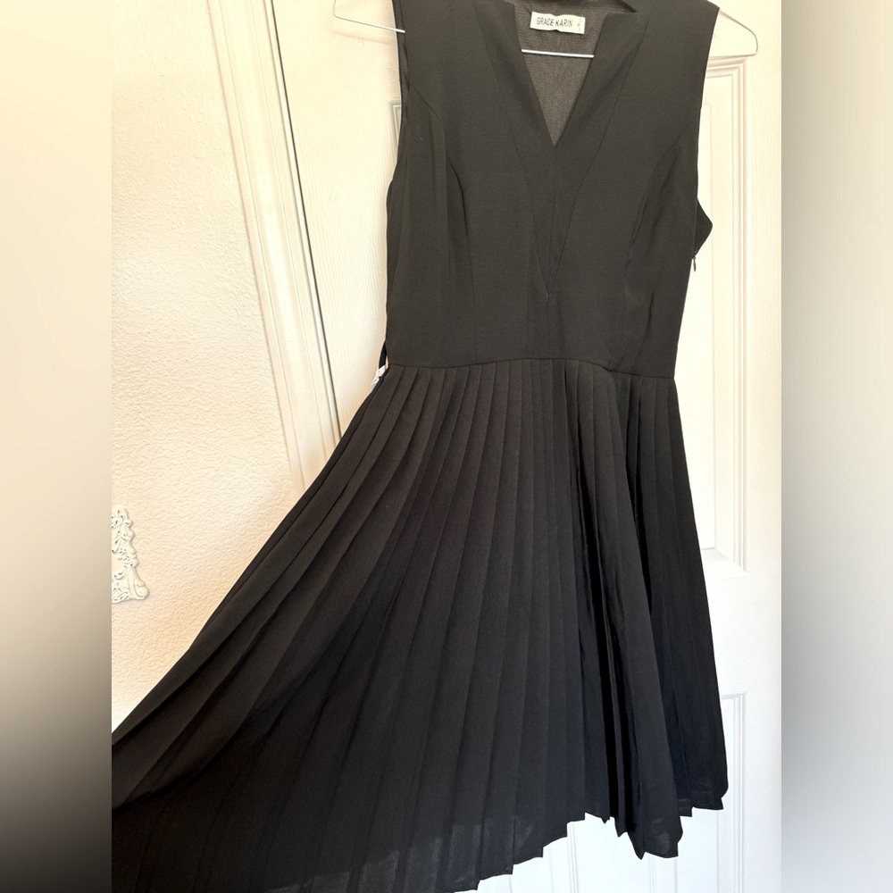 Pleated little black dress, sleeveless, business casual A-line